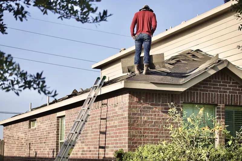 Professional roofer working on a residential roof in Trenton Falls